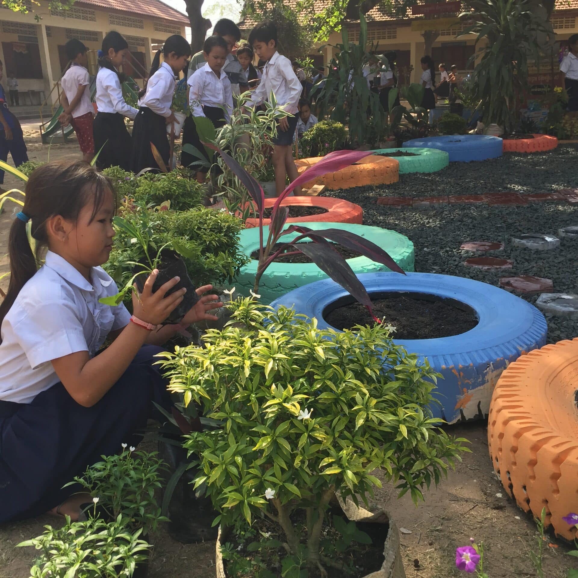 Cambodia Volunteer Trip - Primary School Garden Cambodian girl gardening at local school